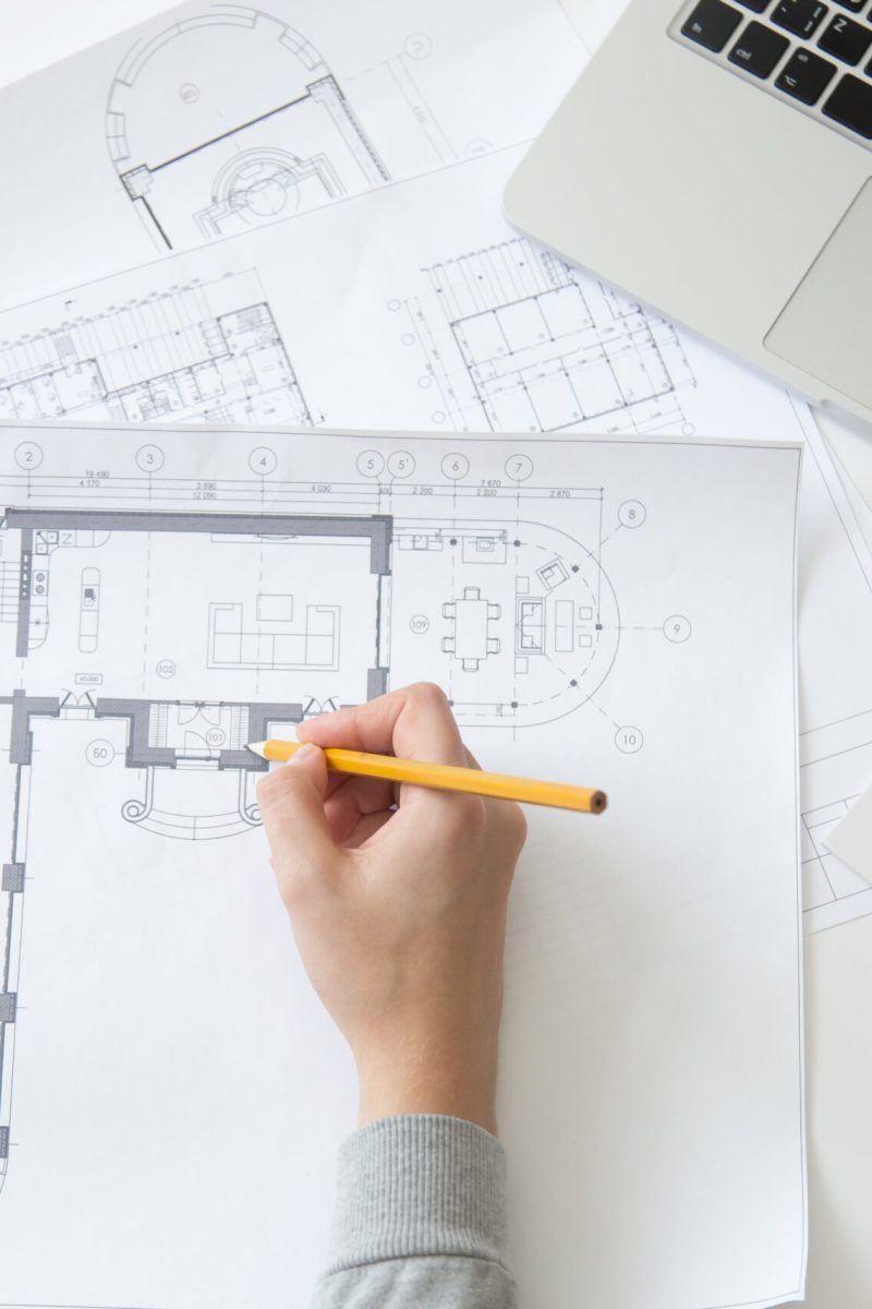 Top view of a hand making an architect drawing at the working desk, close up, education concept photo